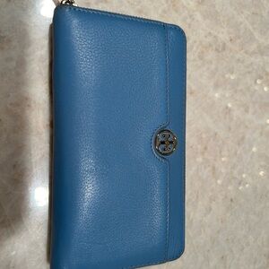 Light blue Tory Burch leather wallet. Gold logo and zipper.